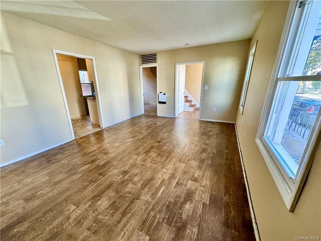 a view of an empty room and wooden floor