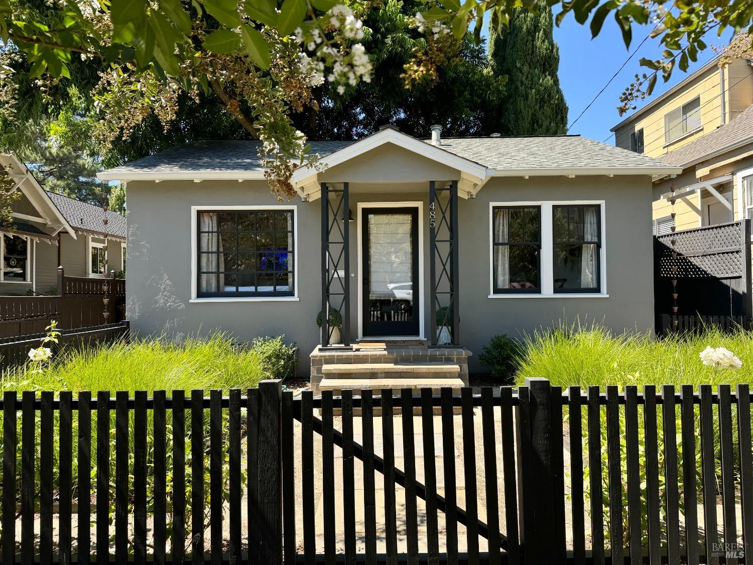 a view of a house with a small yard