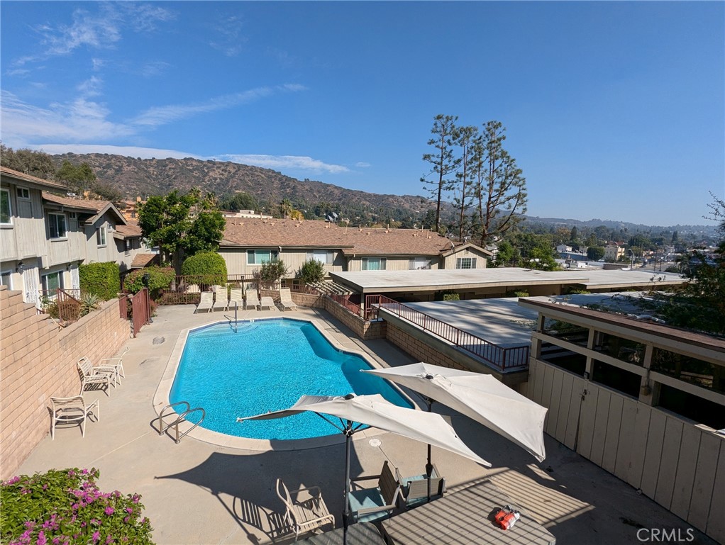 a view of a patio with swimming pool and mountain view