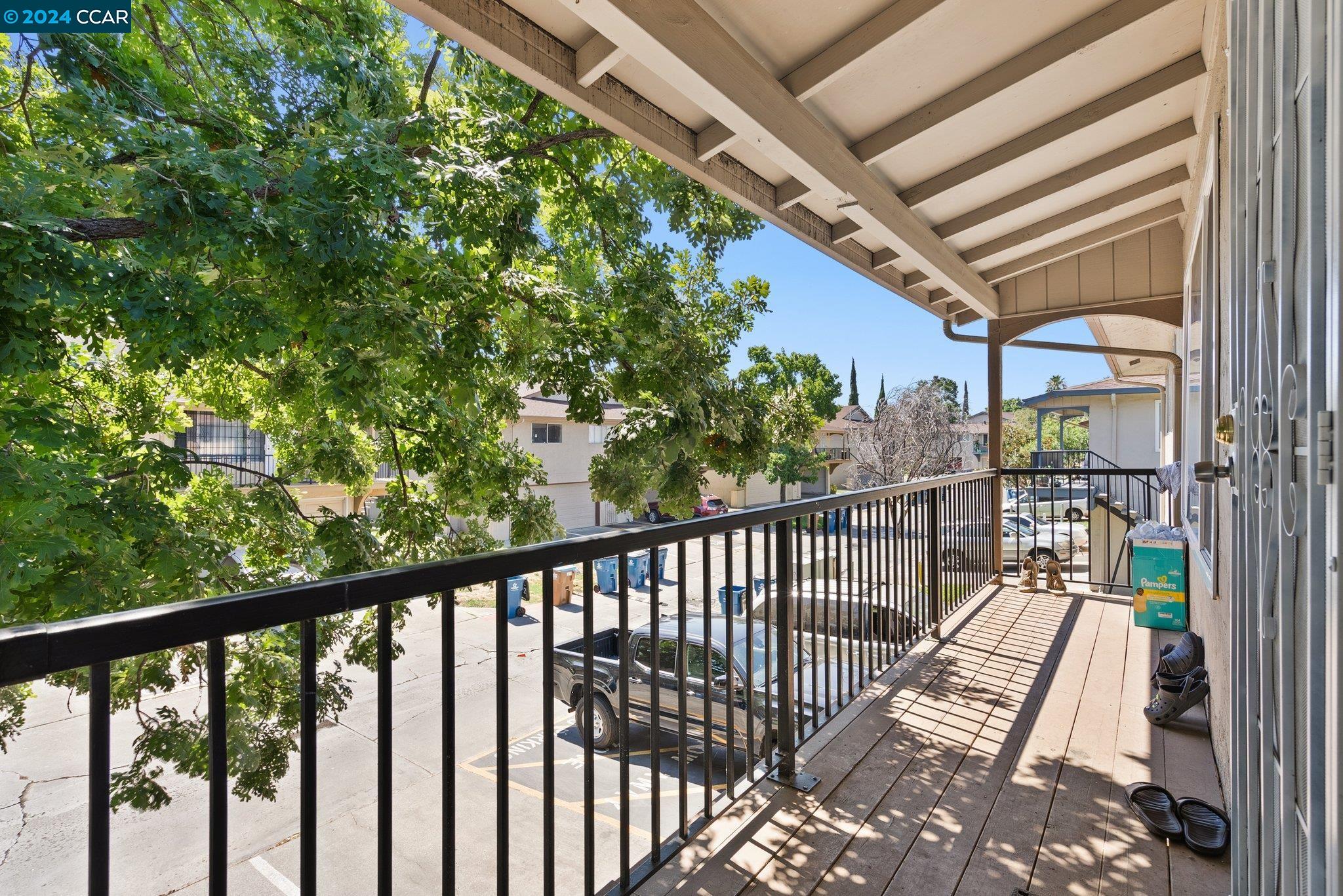 a view of a balcony with wooden floor