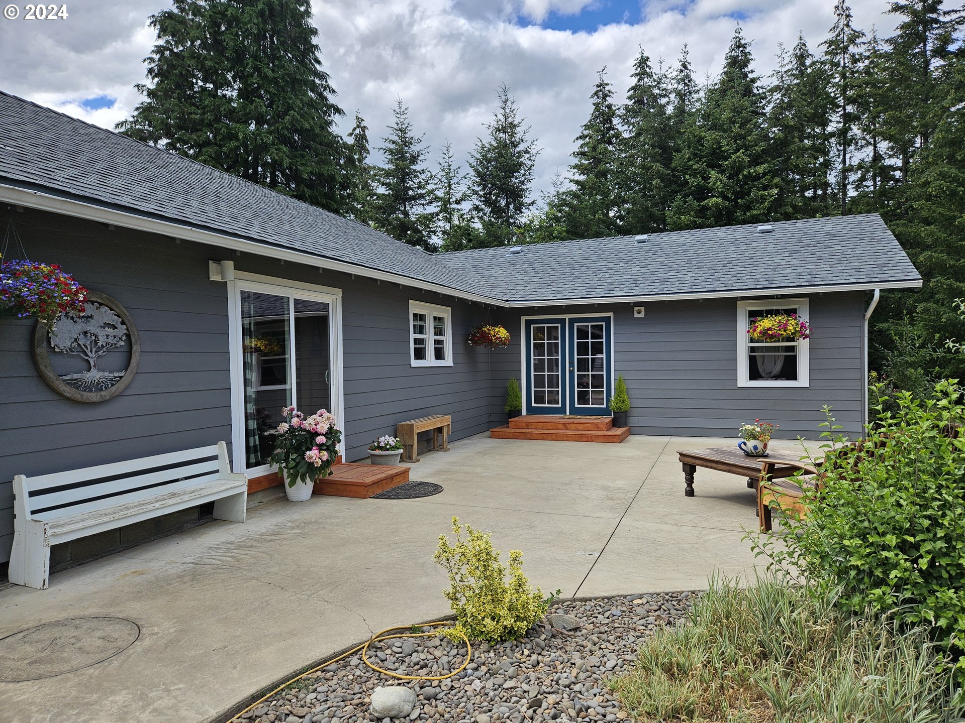 a backyard of a house with yard and outdoor seating