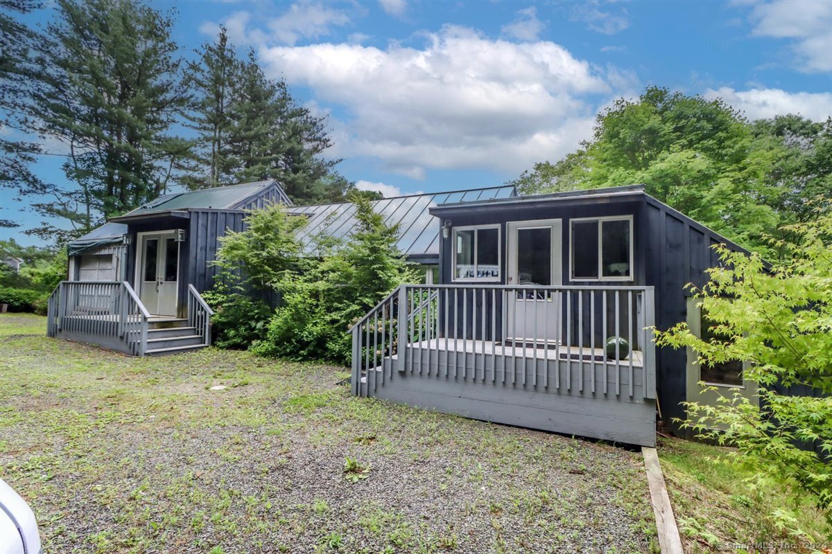 a view of a house with wooden deck and a yard