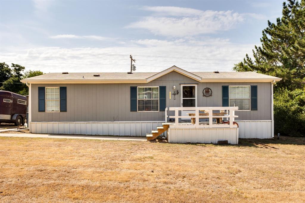 a front view of a house with a basket ball court