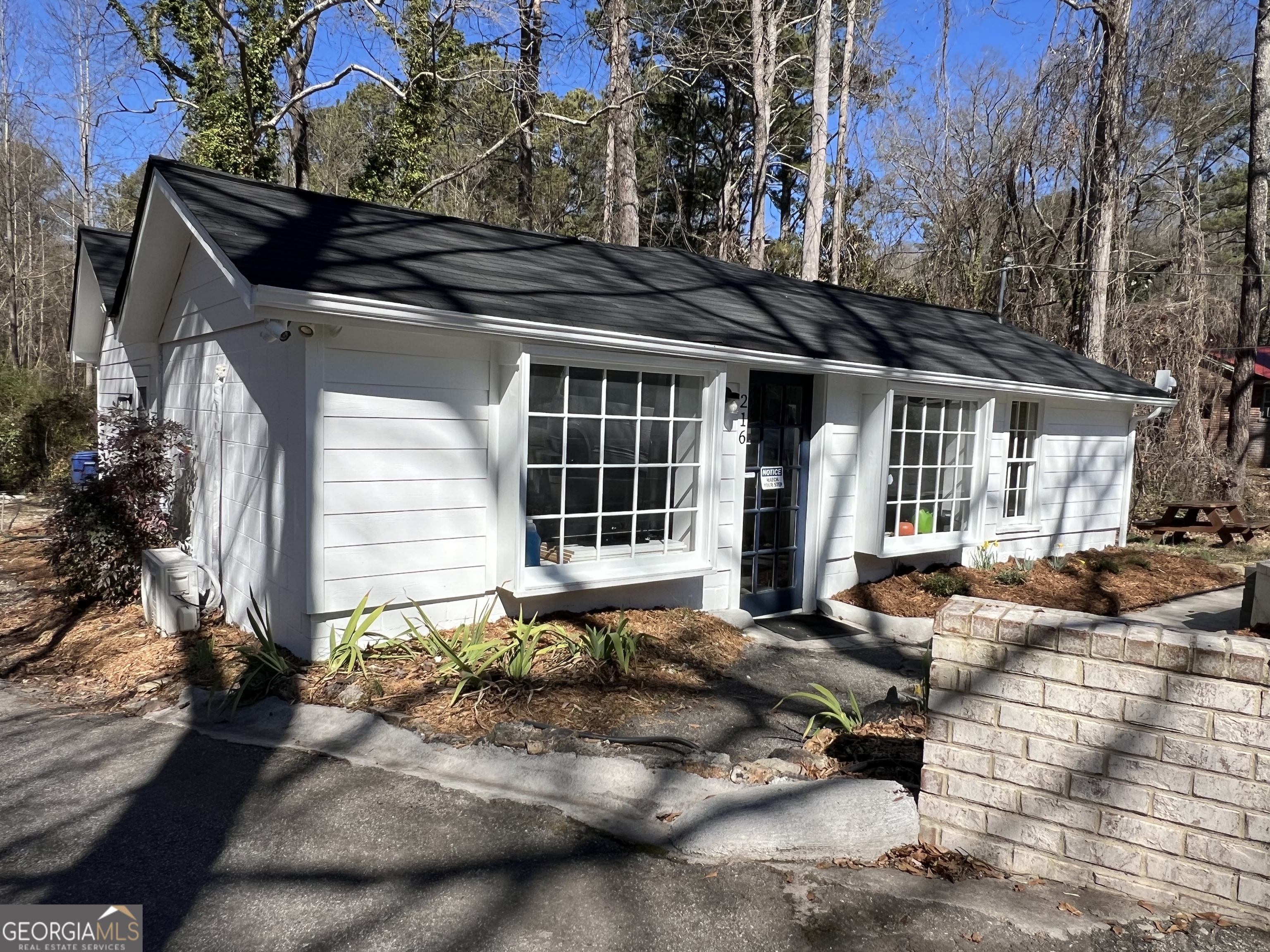 a front view of a house with sitting area