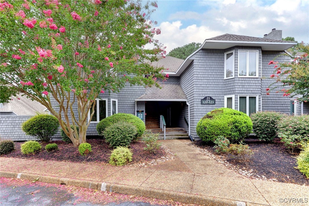 a front view of a house with garden