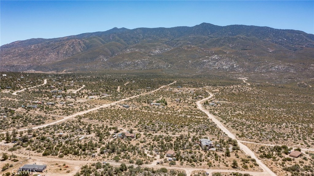 a view of a field with a mountain in the background