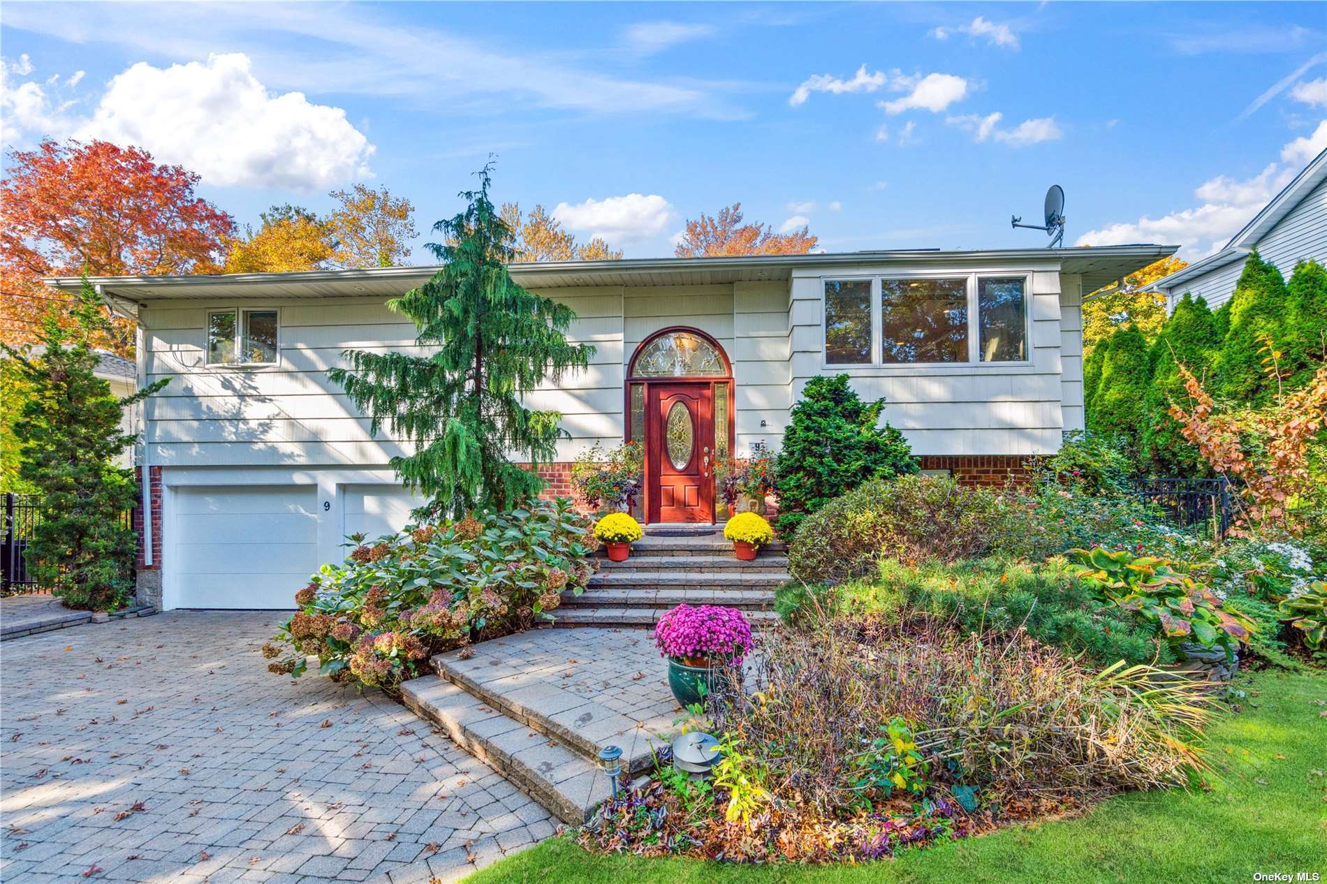 a front view of a house with lots of potted plants