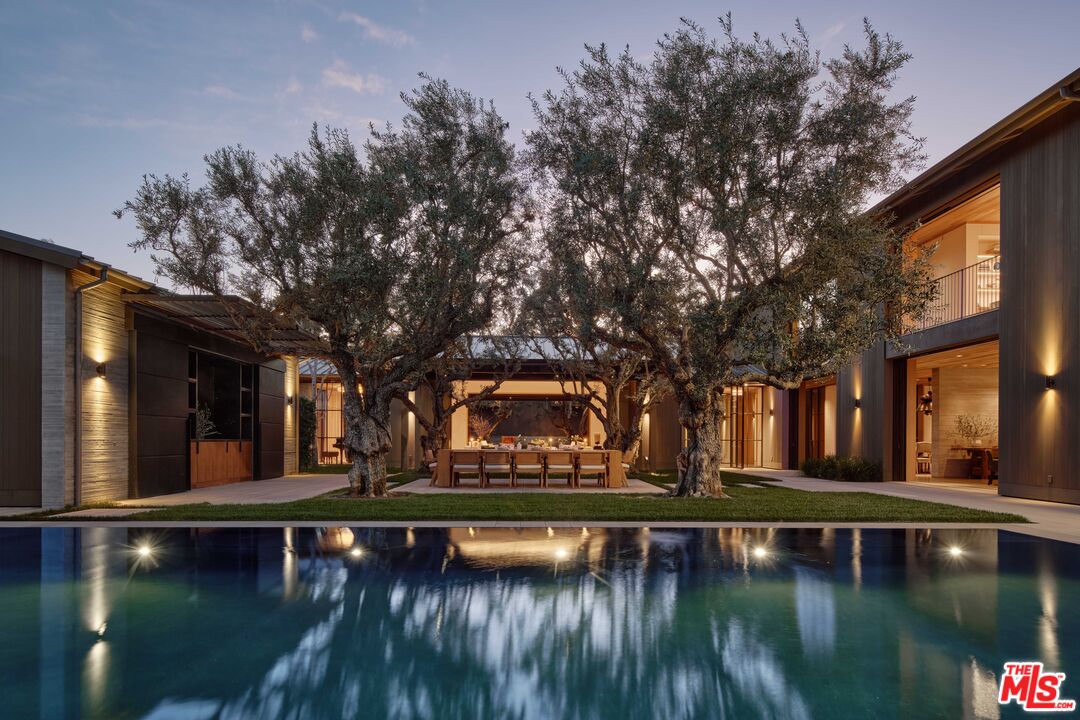 a view of swimming pool with trees in the background