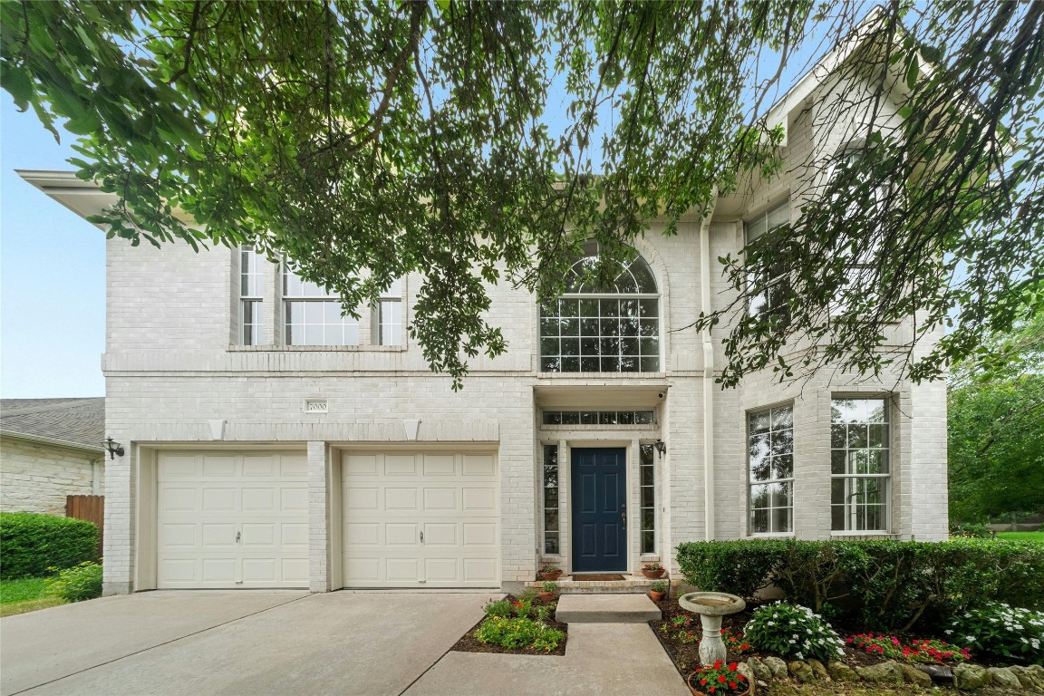 front view of a house with a tree