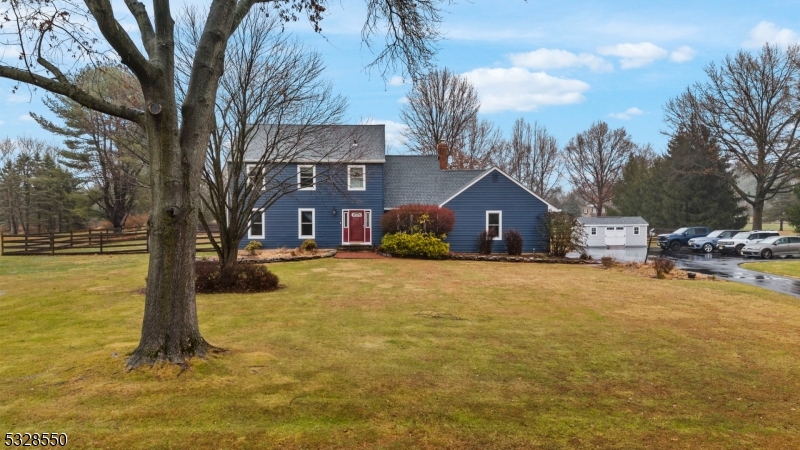 a front view of house with yard and trees