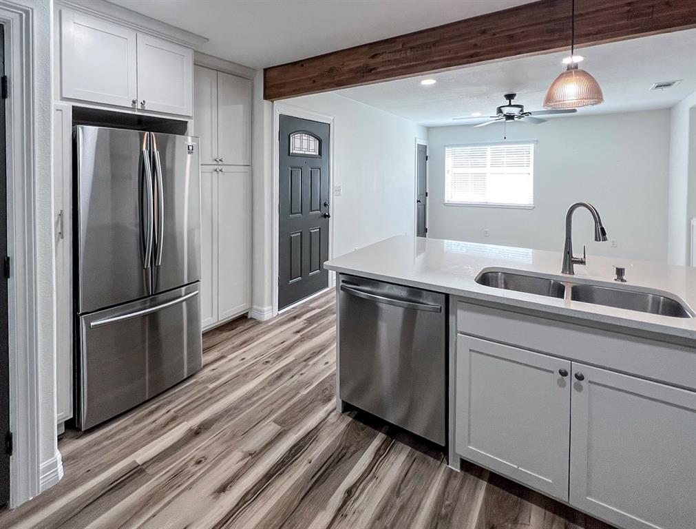 a kitchen with stainless steel appliances a refrigerator and a sink