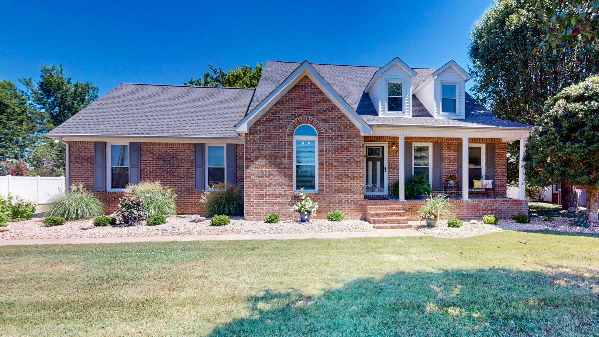 a front view of a house with yard