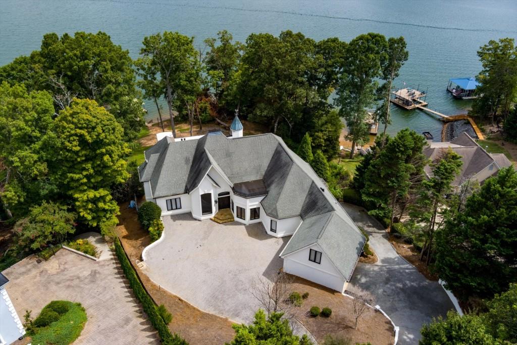 an aerial view of a house with yard