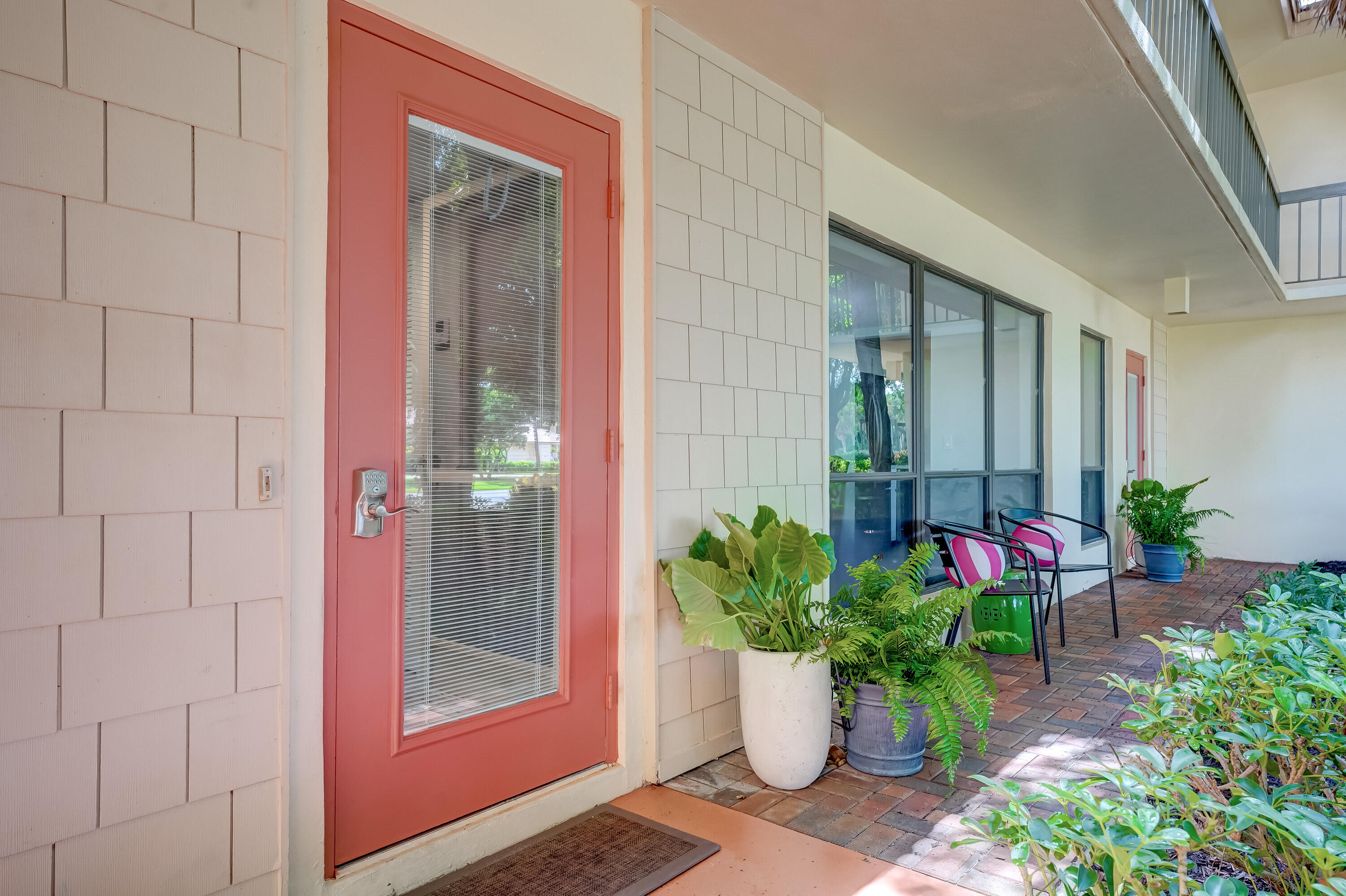 a view of a entryway door of the house with chairs