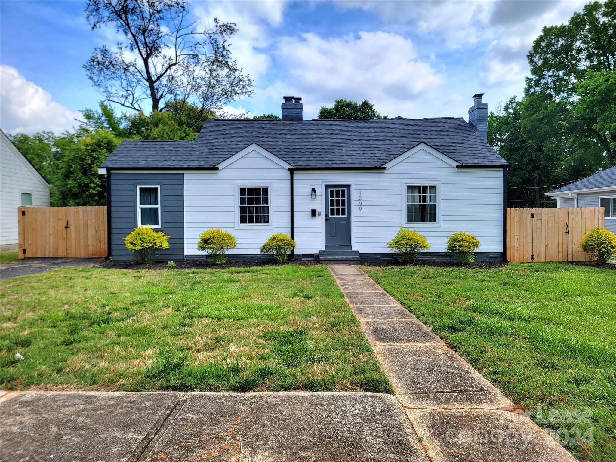 a front view of house with yard and green space