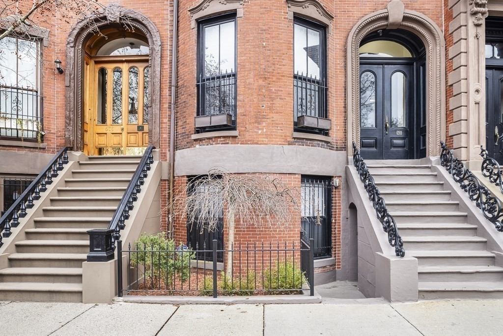 a view of a brick house with large windows