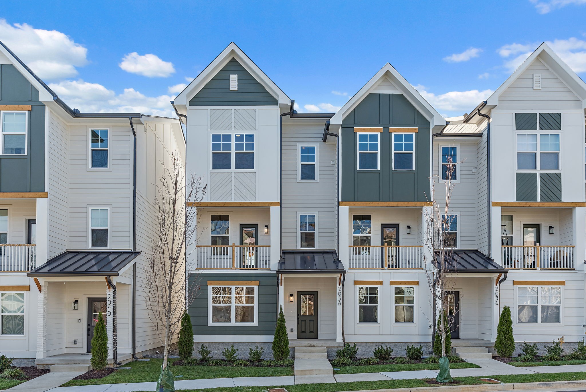 a front view of residential houses with yard