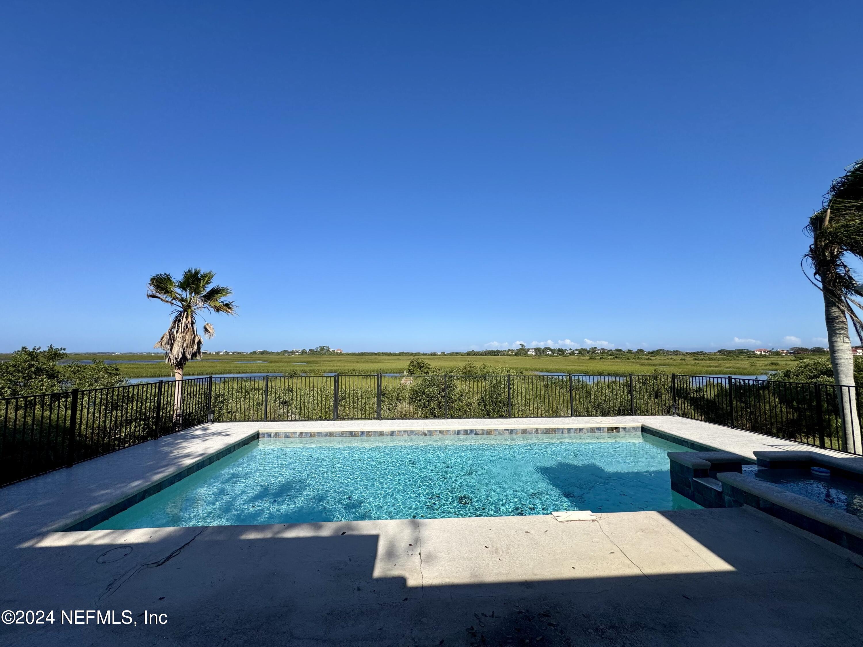 a view of a swimming pool with a yard