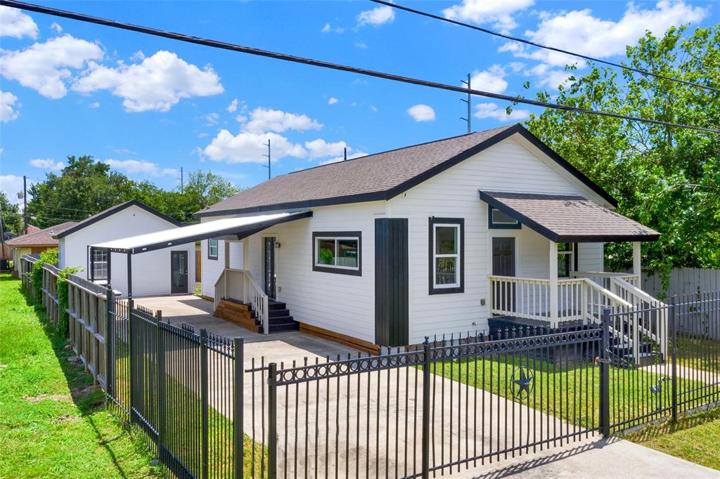 a front view of a house with wooden fence