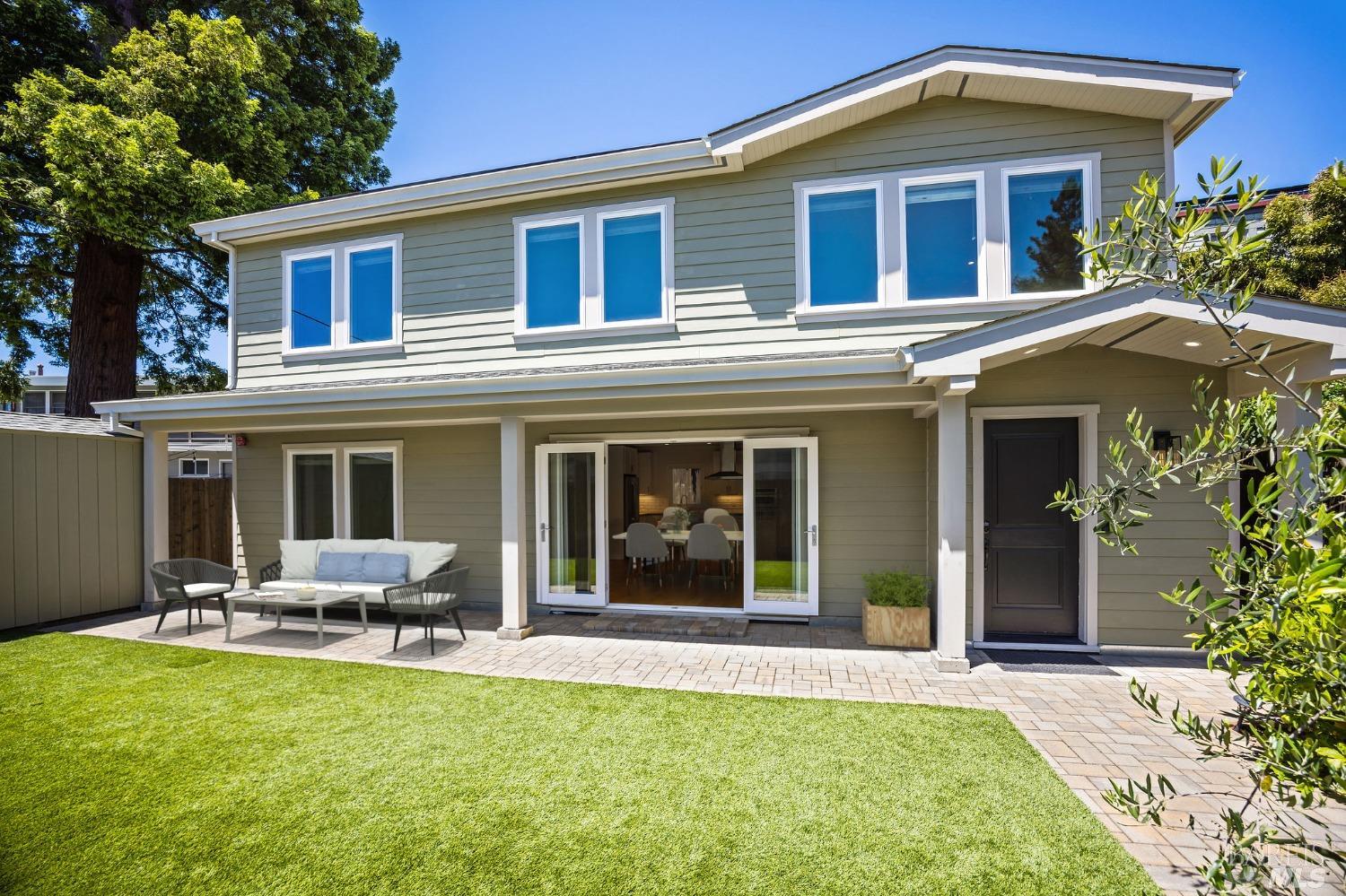 a view of a house with a yard patio and a yard