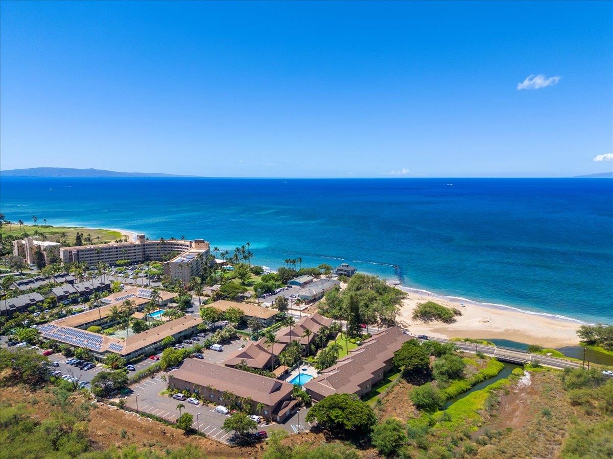 an aerial view of residential building and ocean