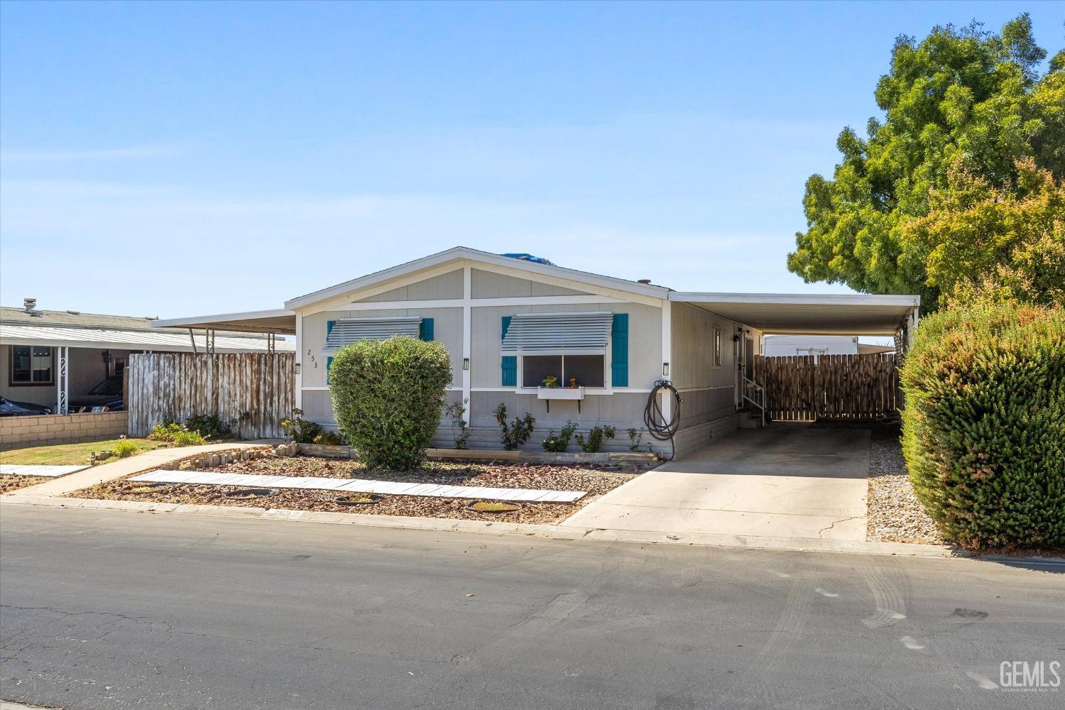 a view of a house with a patio and a yard