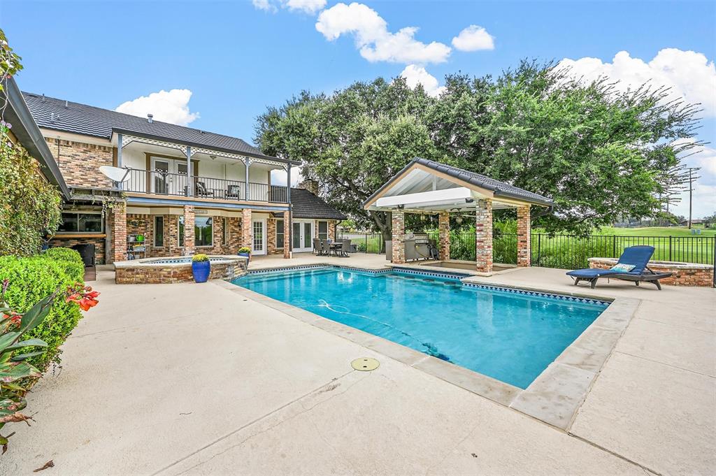 a view of a house with swimming pool and sitting area