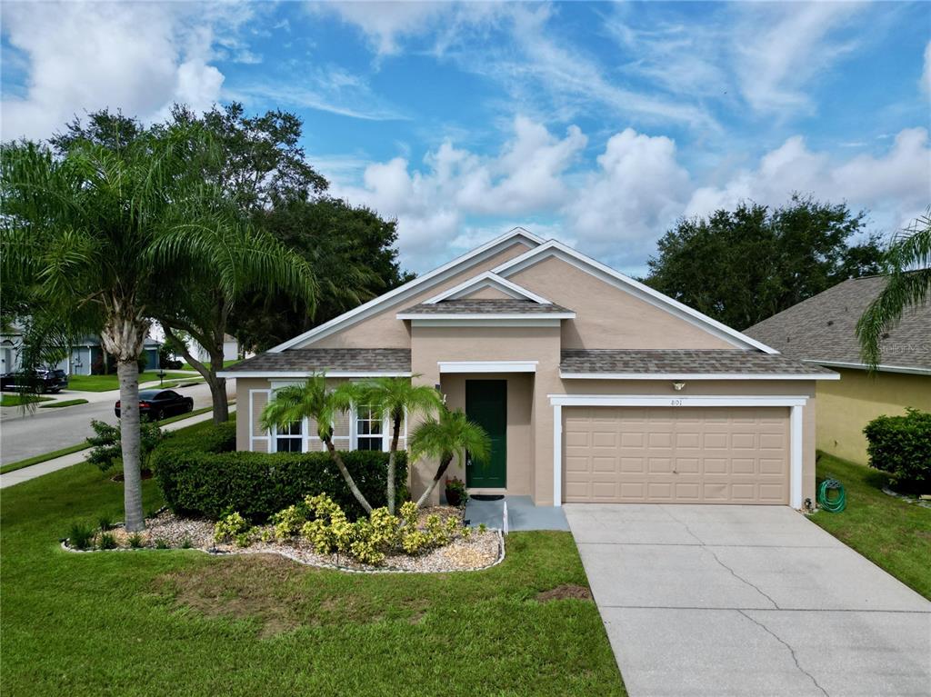 a front view of a house with a yard and garage