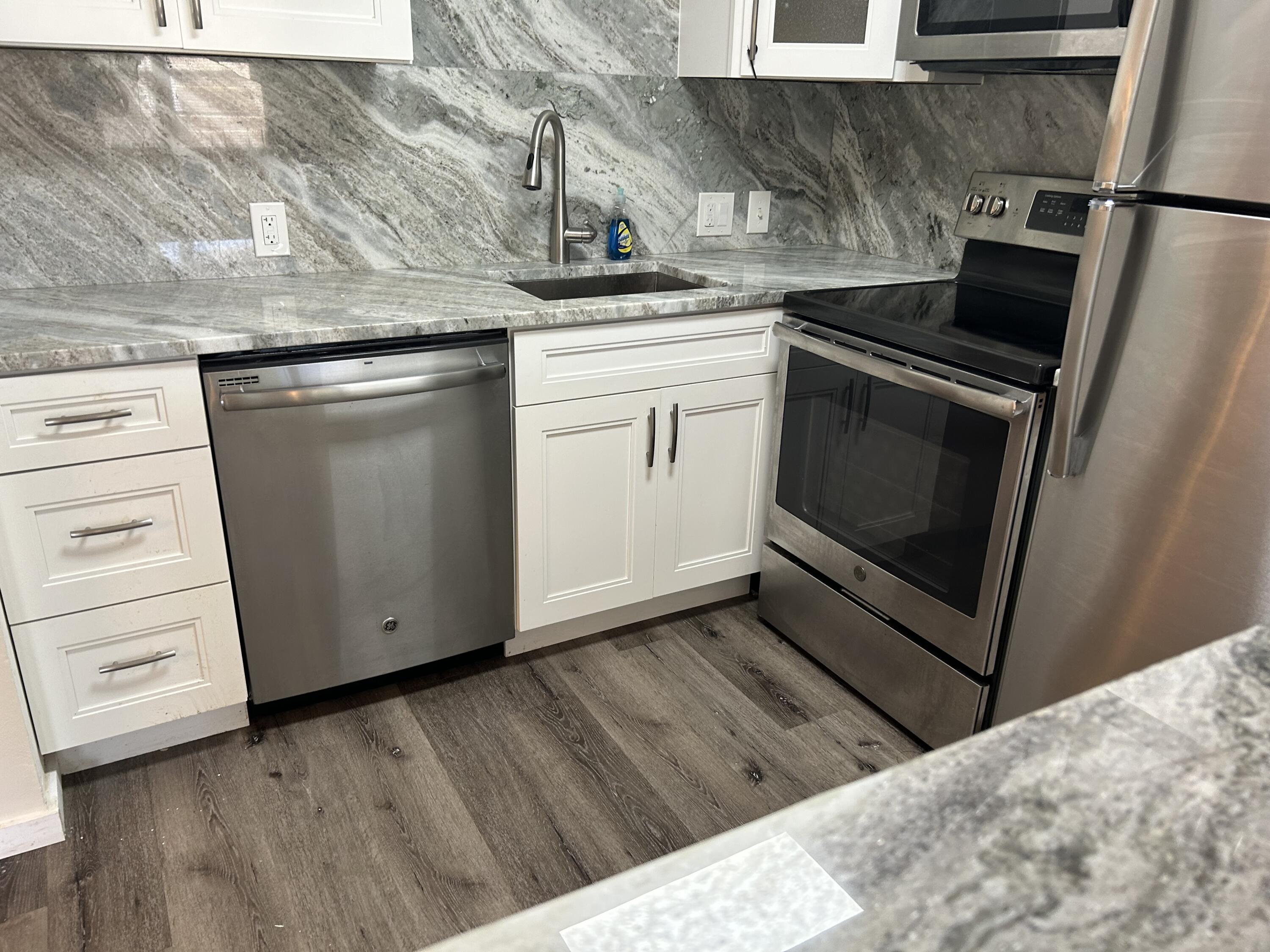 a kitchen with a stove microwave and a sink