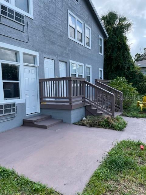 a view of a house with a yard and wooden fence