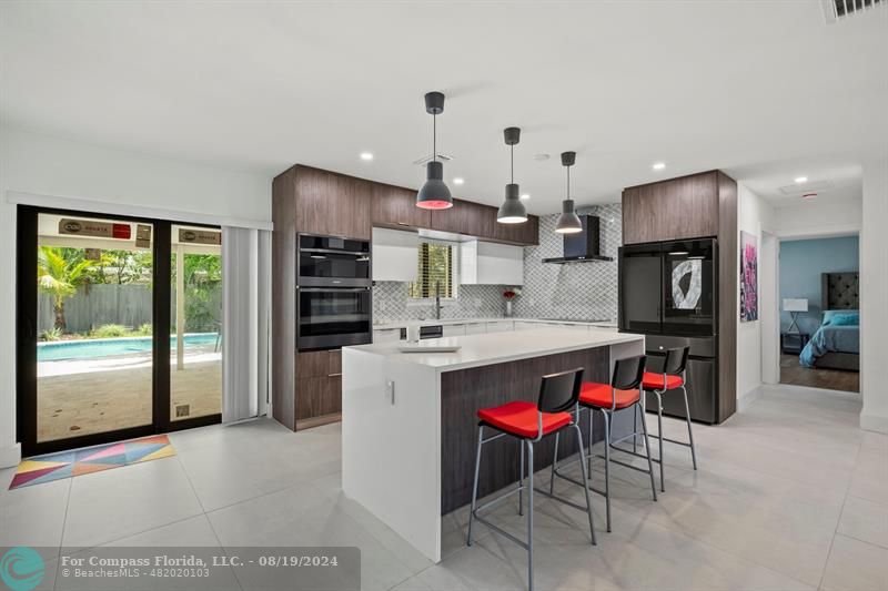 a kitchen with stainless steel appliances granite countertop a refrigerator and a sink