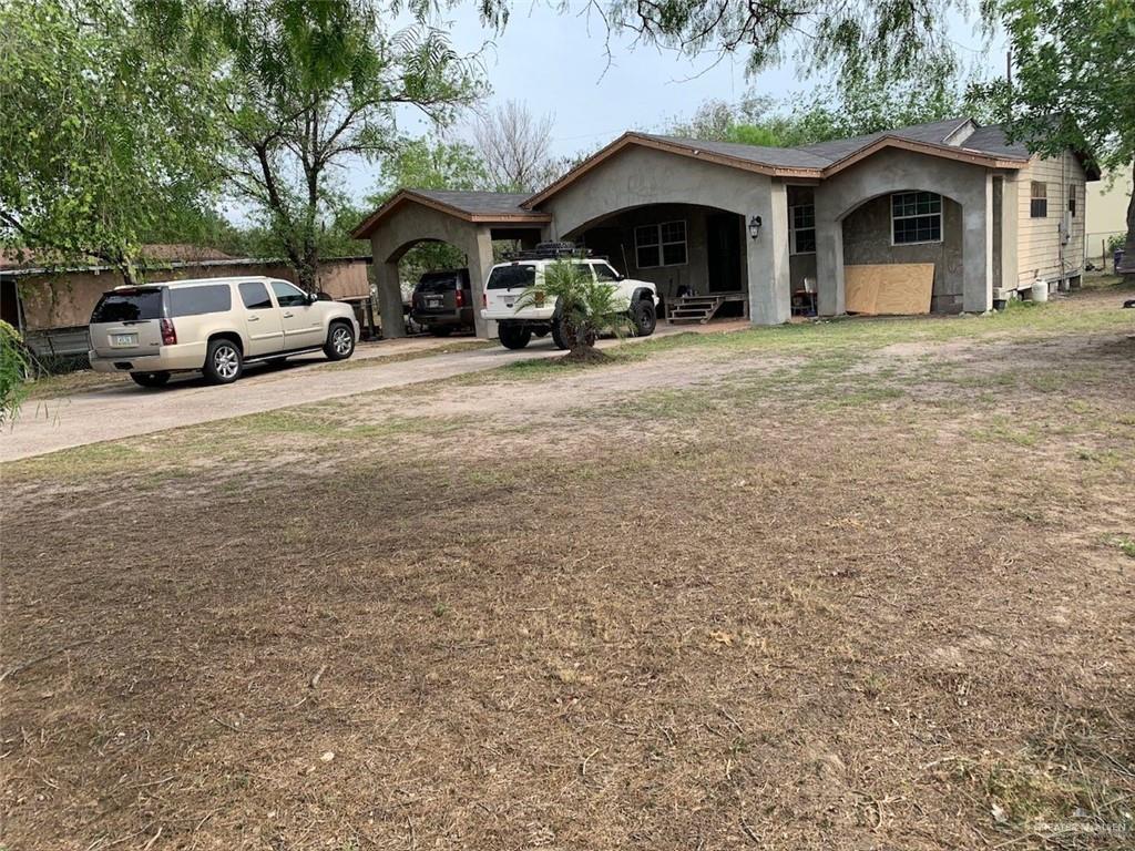 a view of a car parked in front of garage