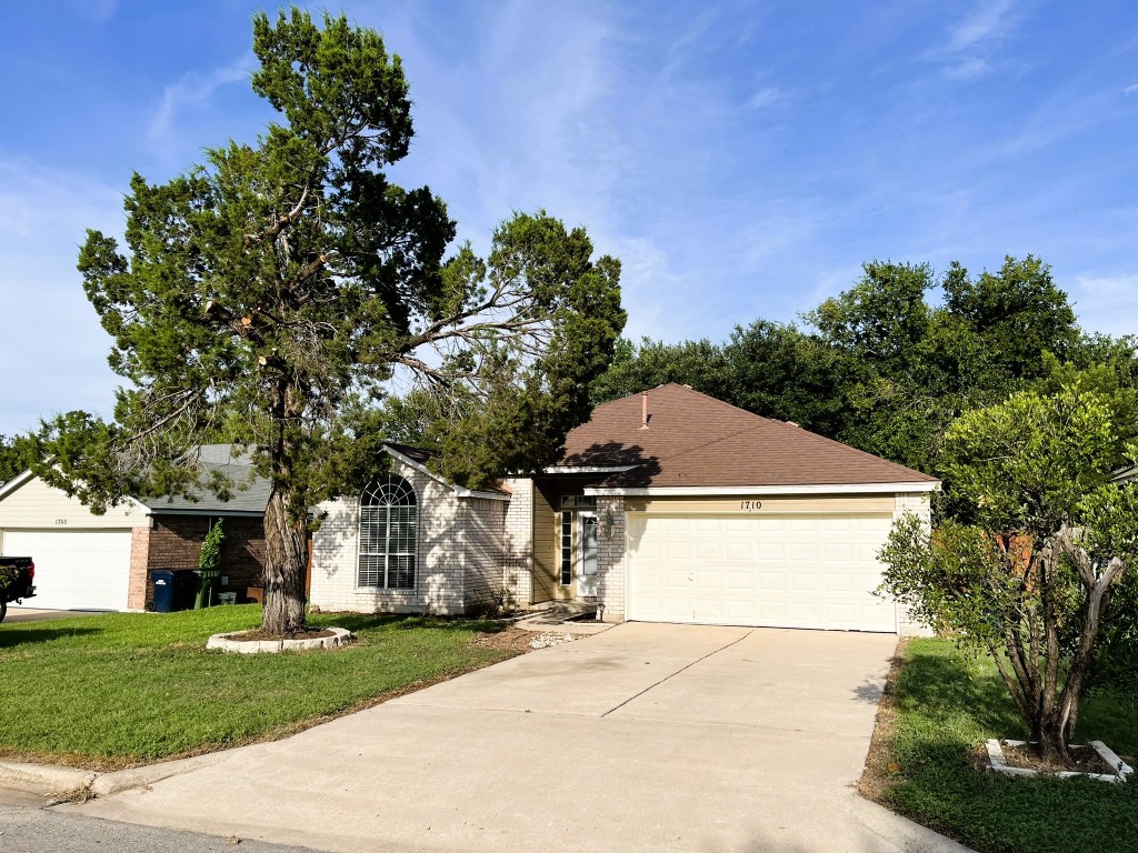 a aerial view of a house with a yard and garage