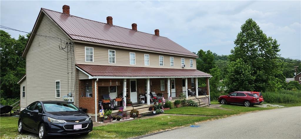 a front view of a house with a garden and porch