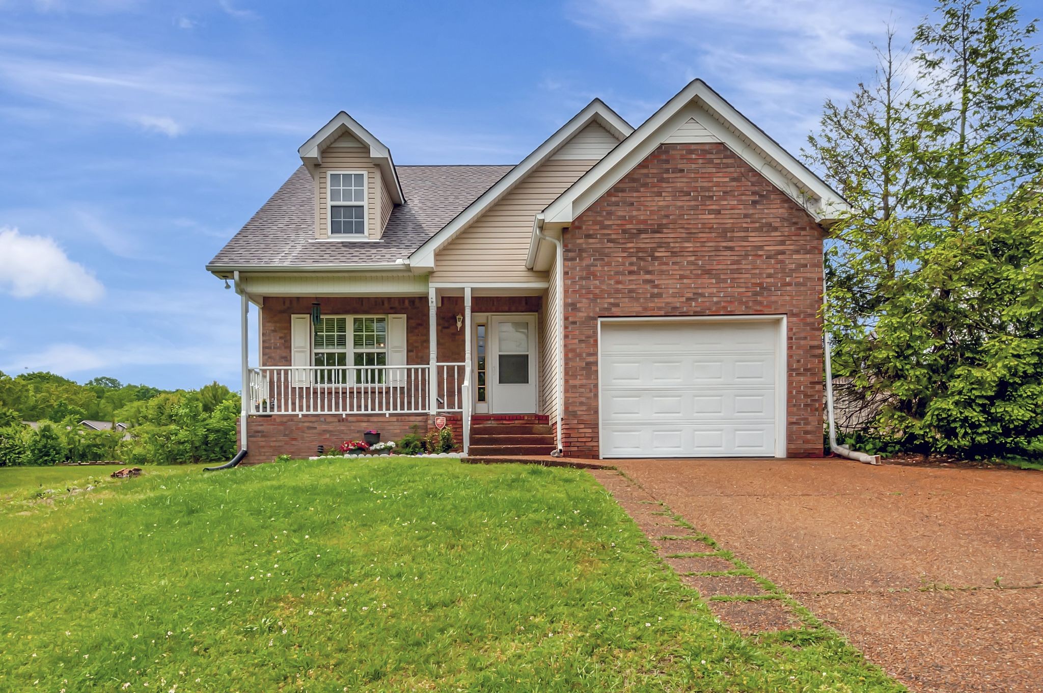 a front view of a house with a yard and garage