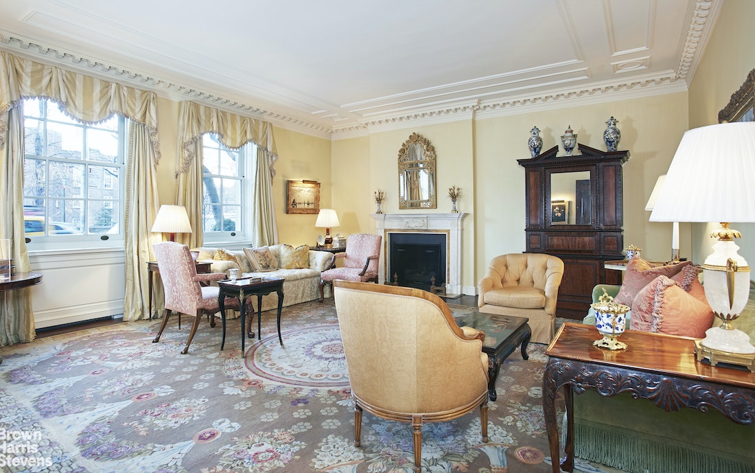 a living room with furniture a fireplace and a table