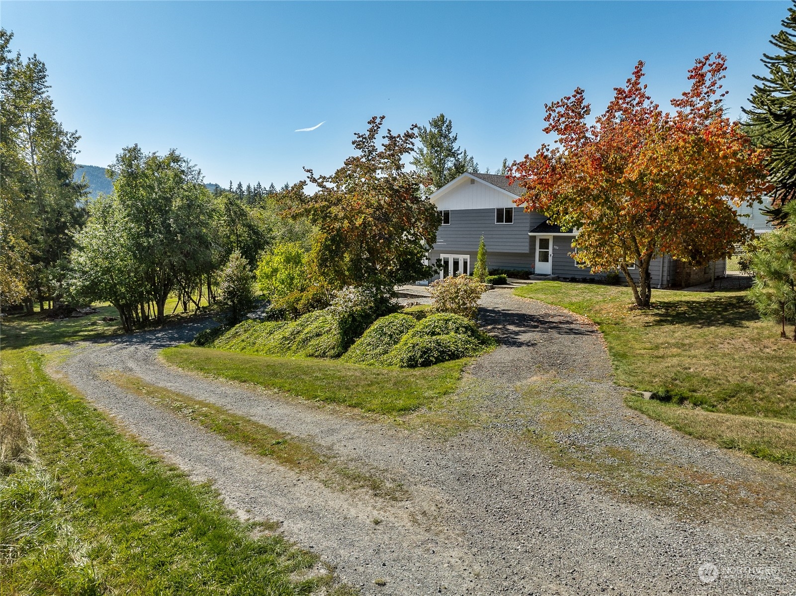 a view of a house with a yard and garage