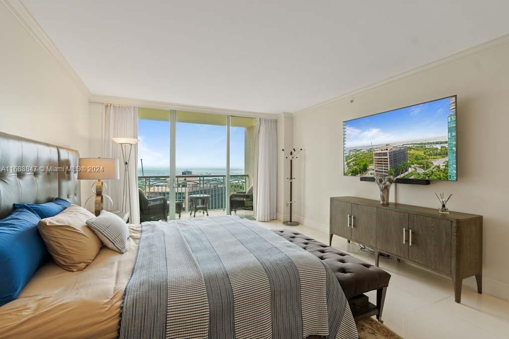 a bedroom with a bed and large windows