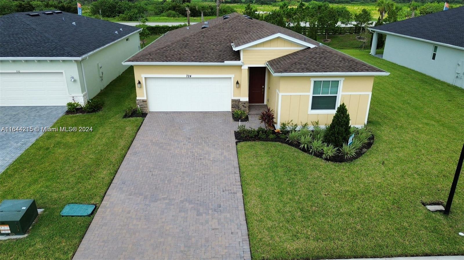 a front view of house with yard and green space