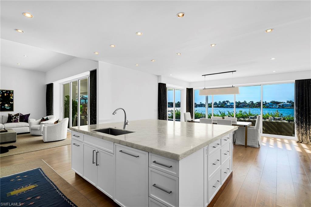 a kitchen with sink attached with living room