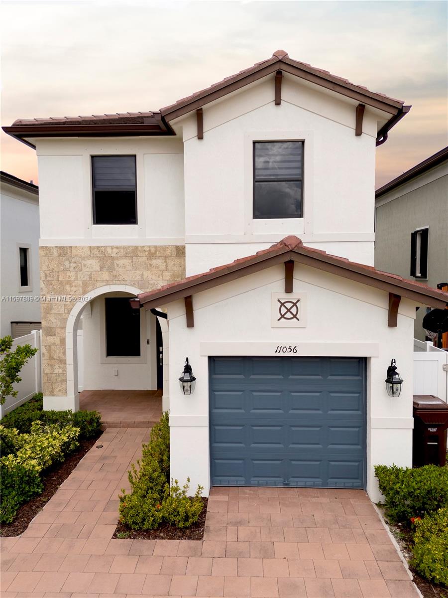 a front view of a house with garage