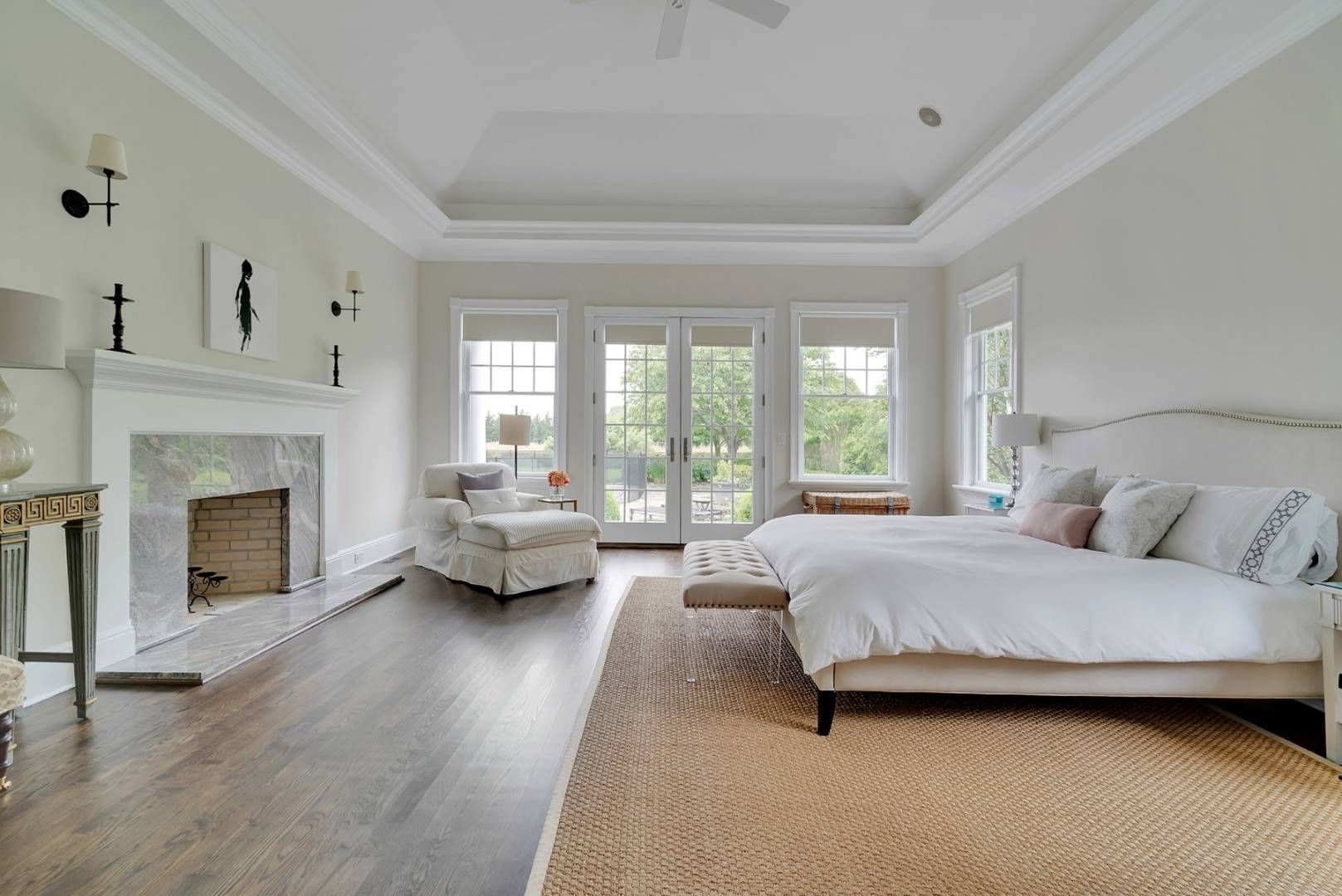 a spacious bedroom with a bed and a fireplace