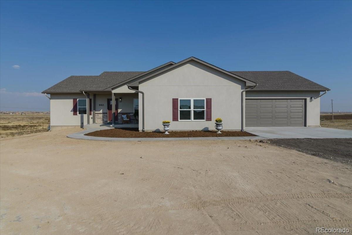 a view of the house with a yard and garage