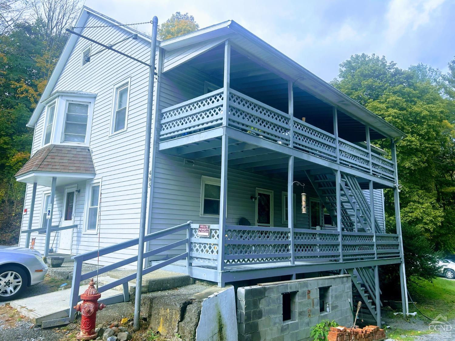 a view of a house with more windows and potted plants