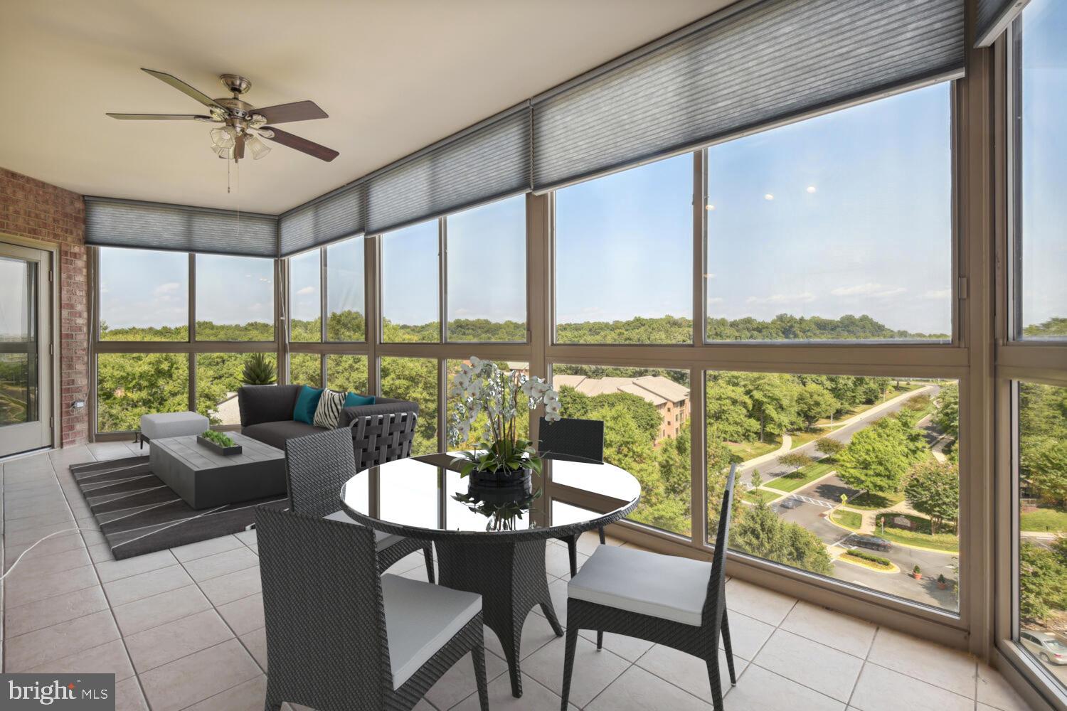 a living room with furniture and a floor to ceiling window