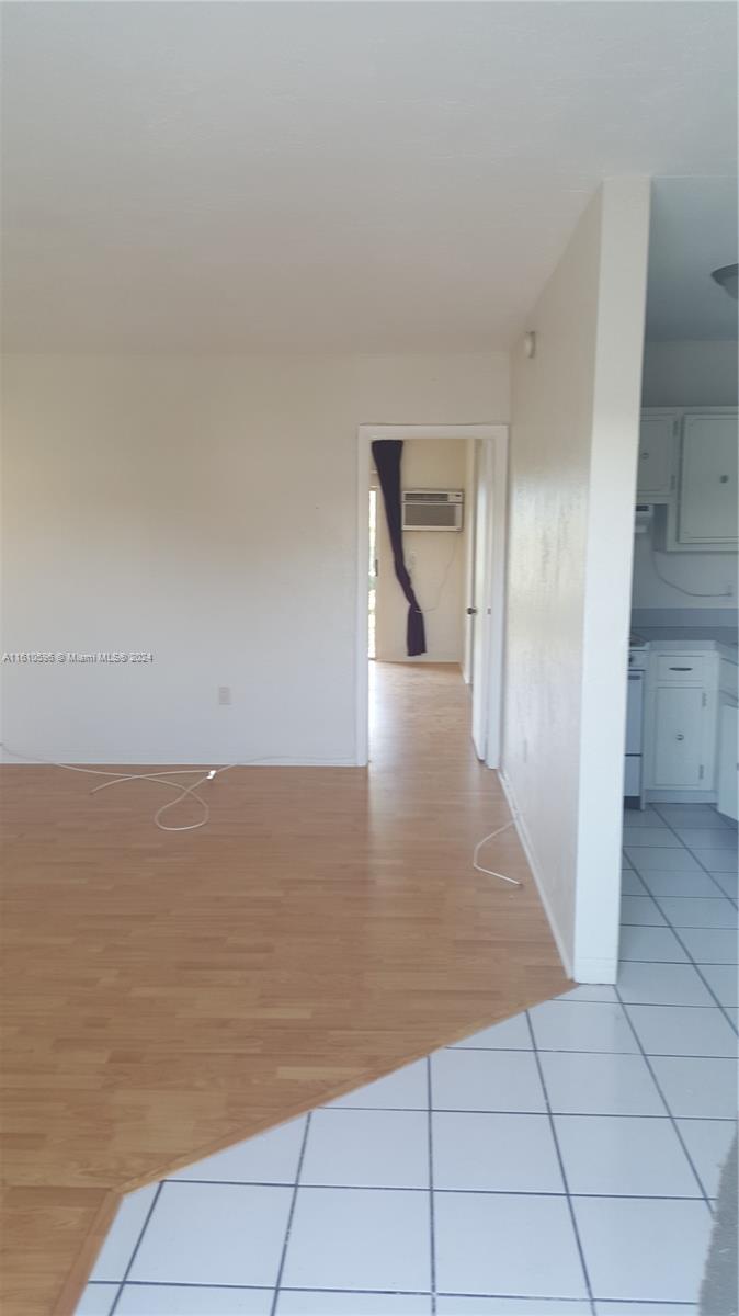 a view of a room with an empty space and wooden floor