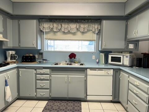 a kitchen with stainless steel appliances a stove a sink and white cabinets