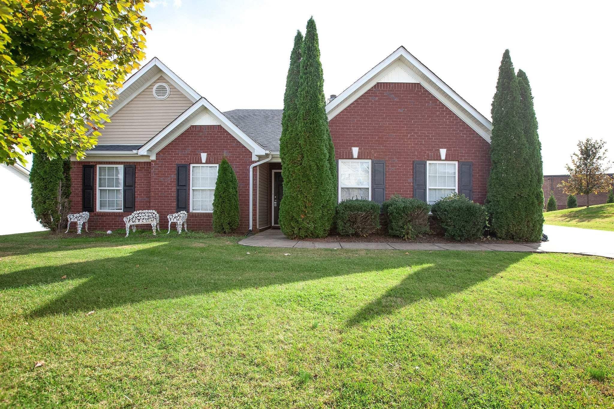 a front view of house with yard and green space