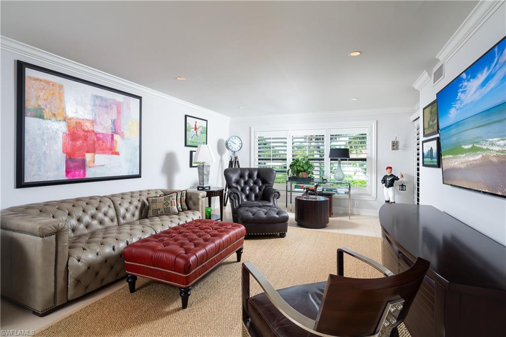 Tiled living room featuring ornamental molding