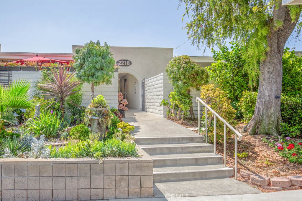 a view of a house with fountain and potted plants